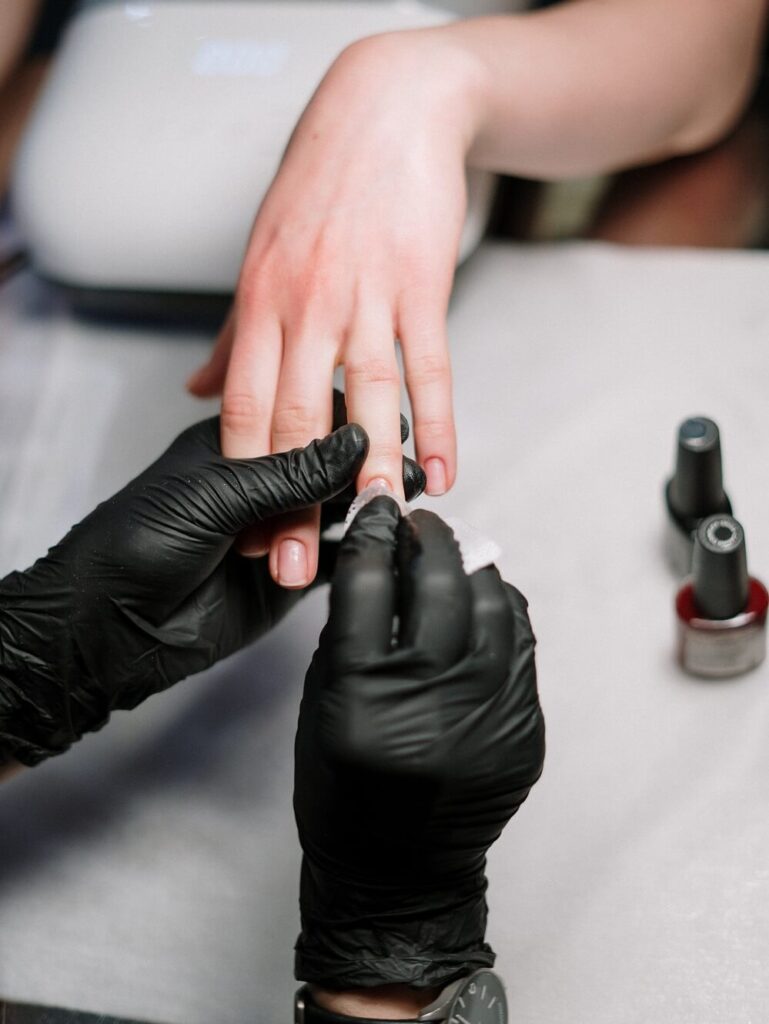 Person getting their nails done by a nail tech