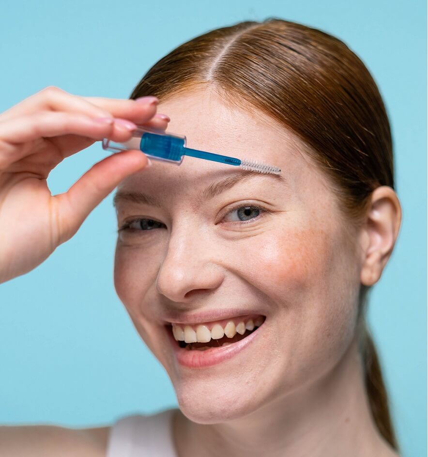 Woman applying eyebrow gel