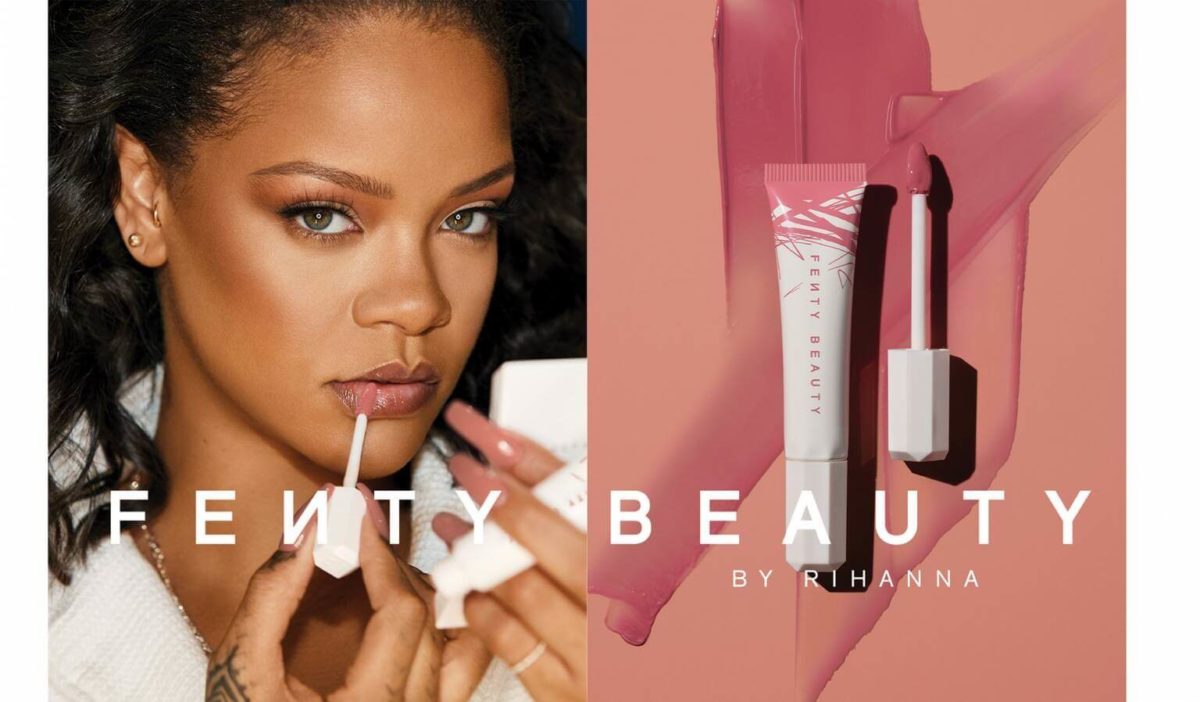 rhianna with fenty beauty products and logo