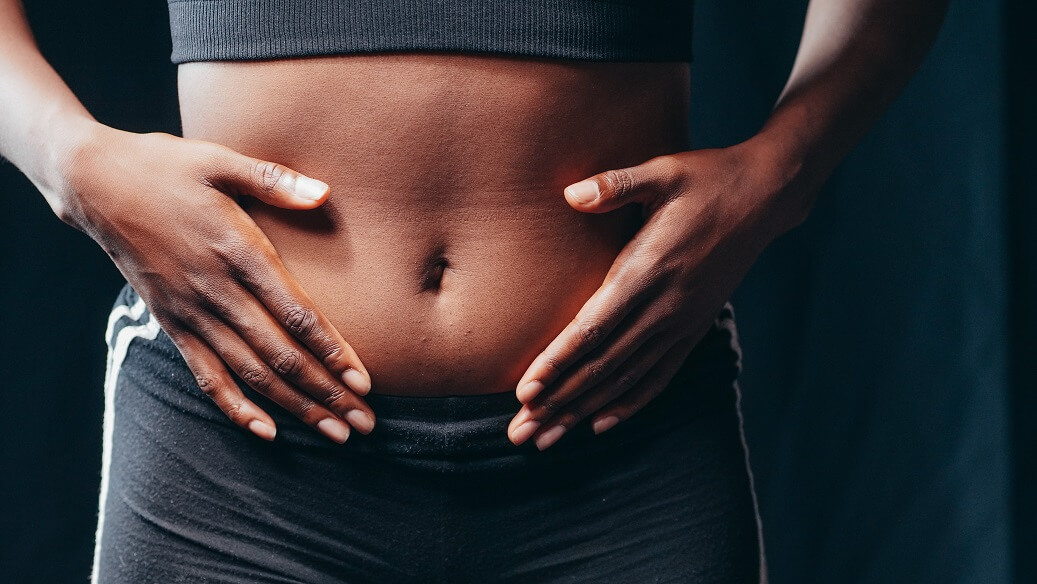 Woman touching her bloated stomach