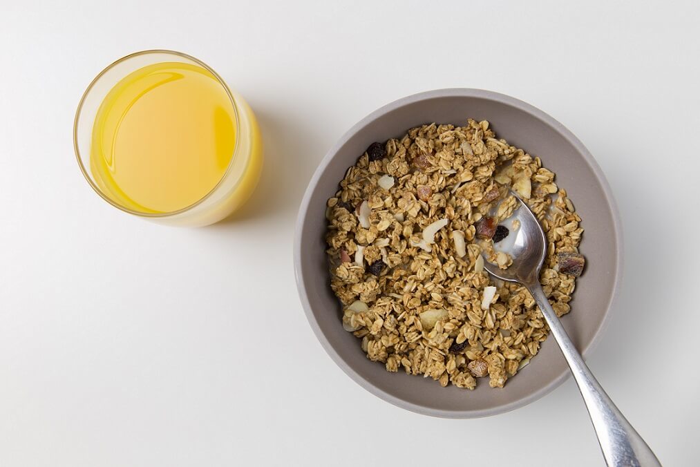A bowl of oats and a glass of orange juice