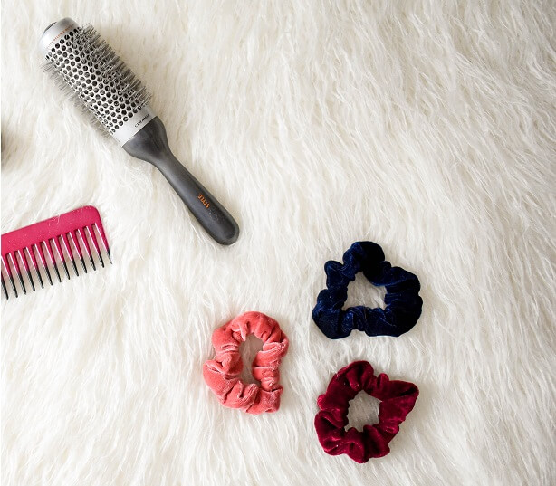 A hairbrush, comb, and scrunchies