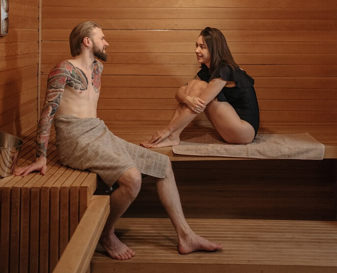Couple sitting in a sauna